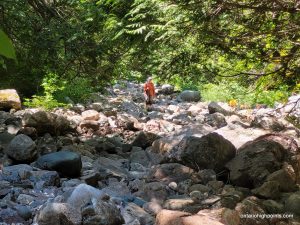 Descending back down the boulder strewn creek bed